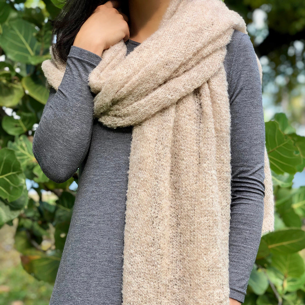Almond alpaca-blend scarf draped around a model’s neck over a gray top