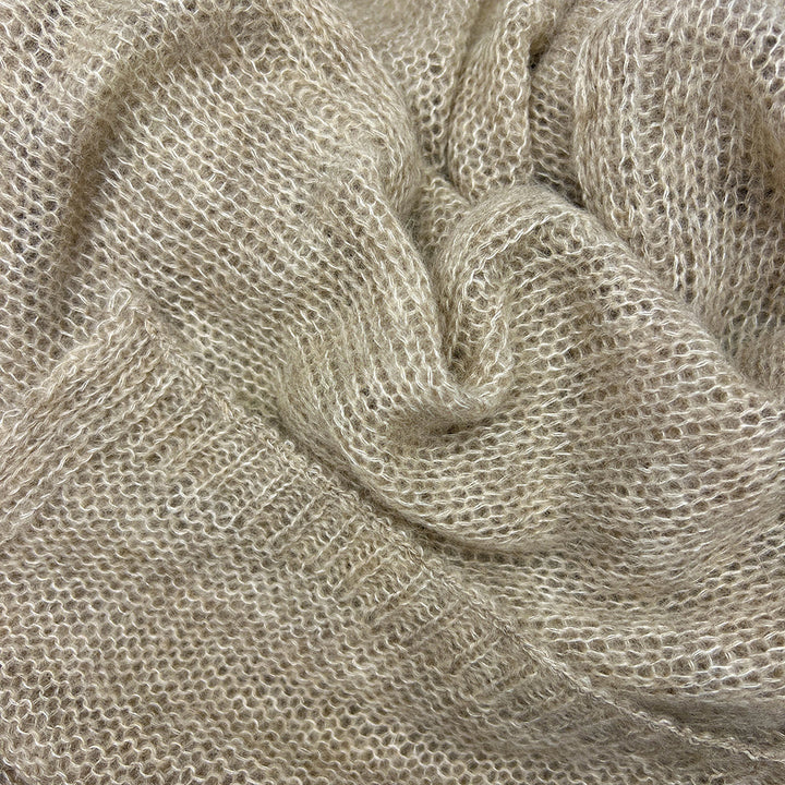 Close-up of Soft beige alpaca and merino blend scarf with subtle knit texture