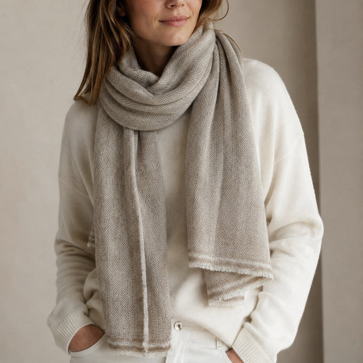 Beige Himalayan cashmere scarf worn on a model, with herringbone