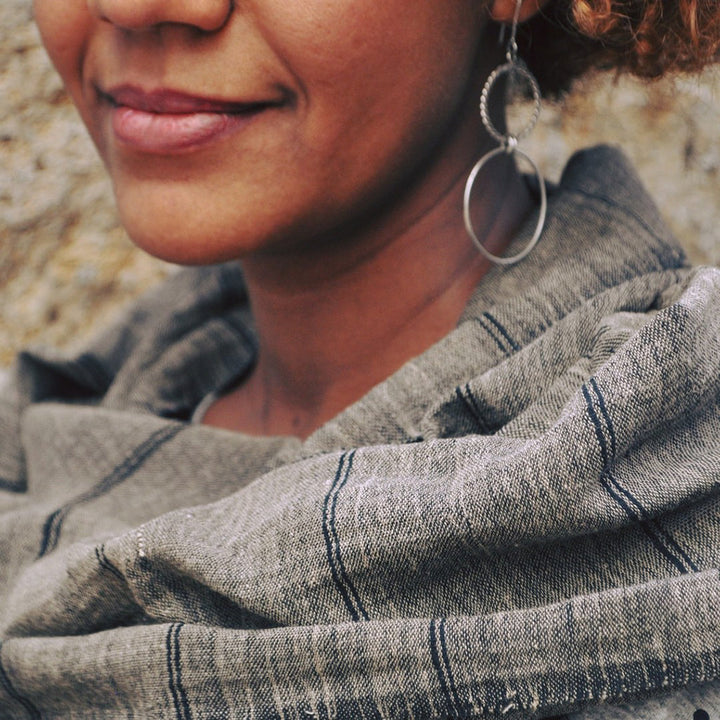 Ash cotton scarf with stripes on a black warp worn by a woman