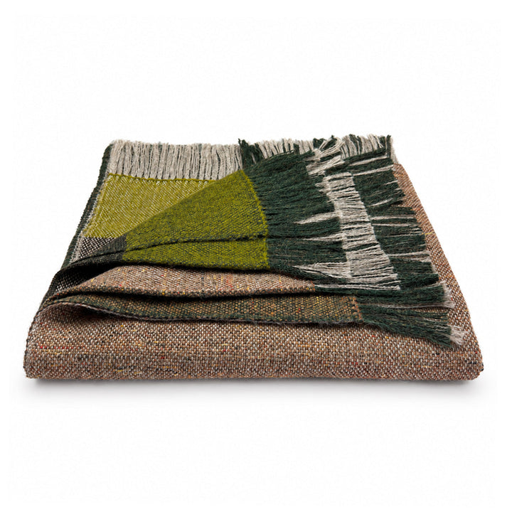 A folded woven throw blanket with a multicolor herringbone pattern in brown, beige, olive green, and dark forest green, featuring fringed edges, shown on a plain white background.