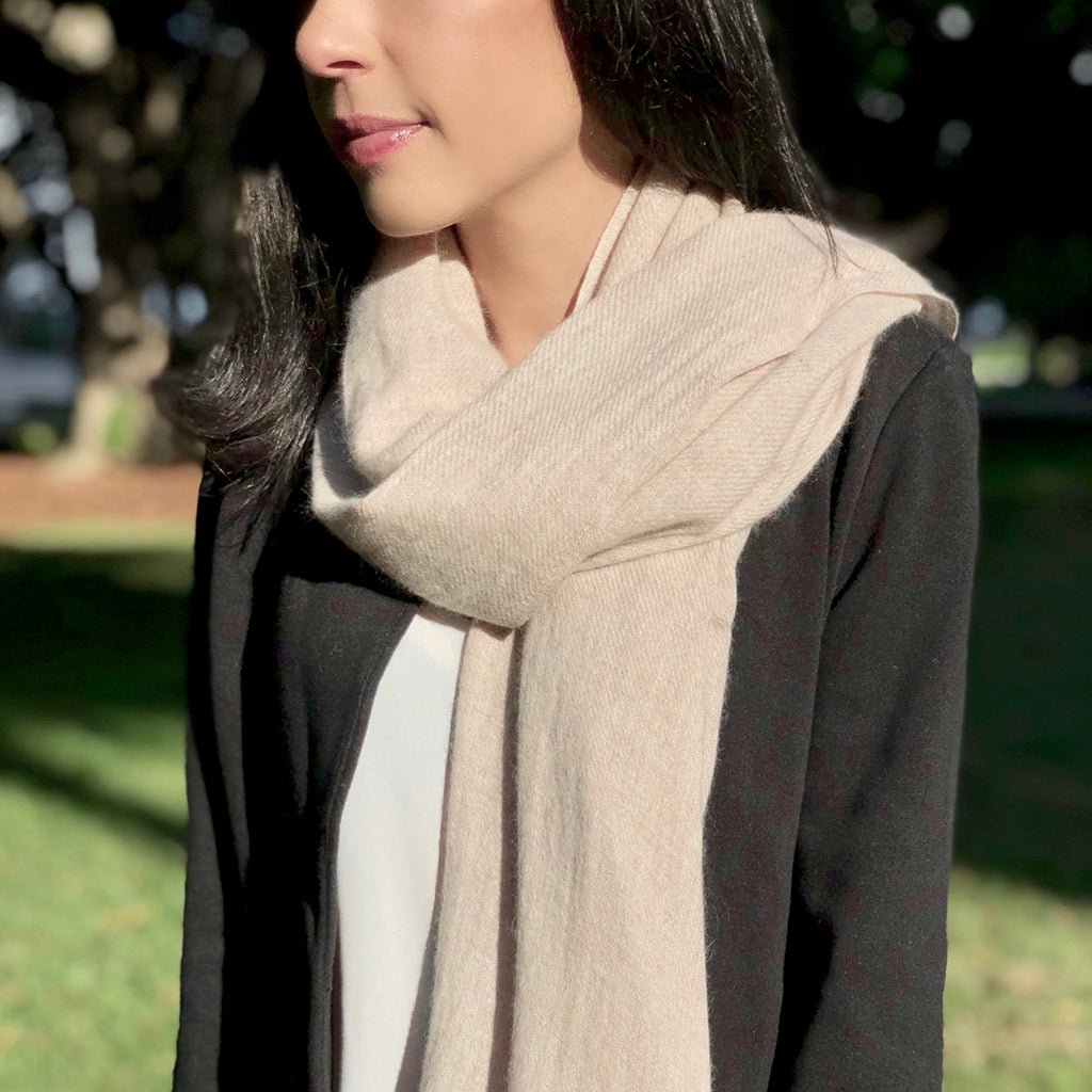 Blush Himalayan cashmere scarf with a soft textile finish worn by a model
