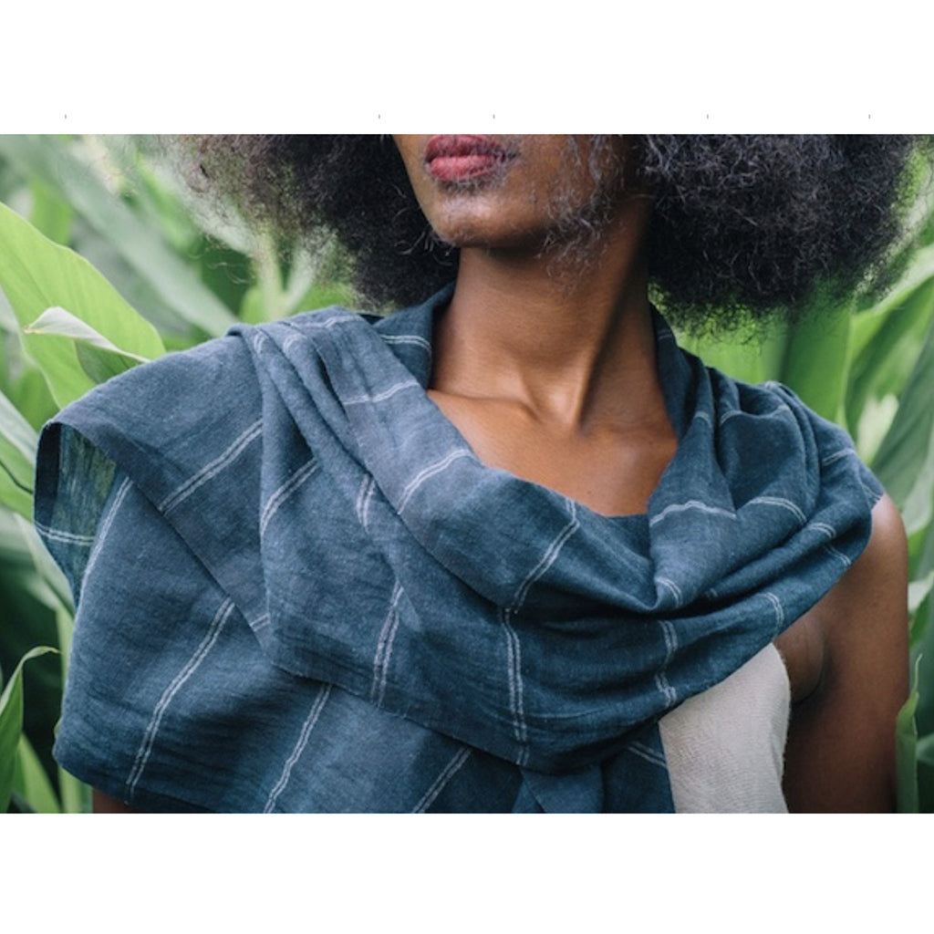 Navy cotton scarf with stripes on a black warp worn by a woman