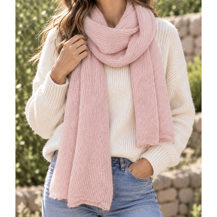 Baby pink alpaca and merino blend scarf worn on a model, with open knit