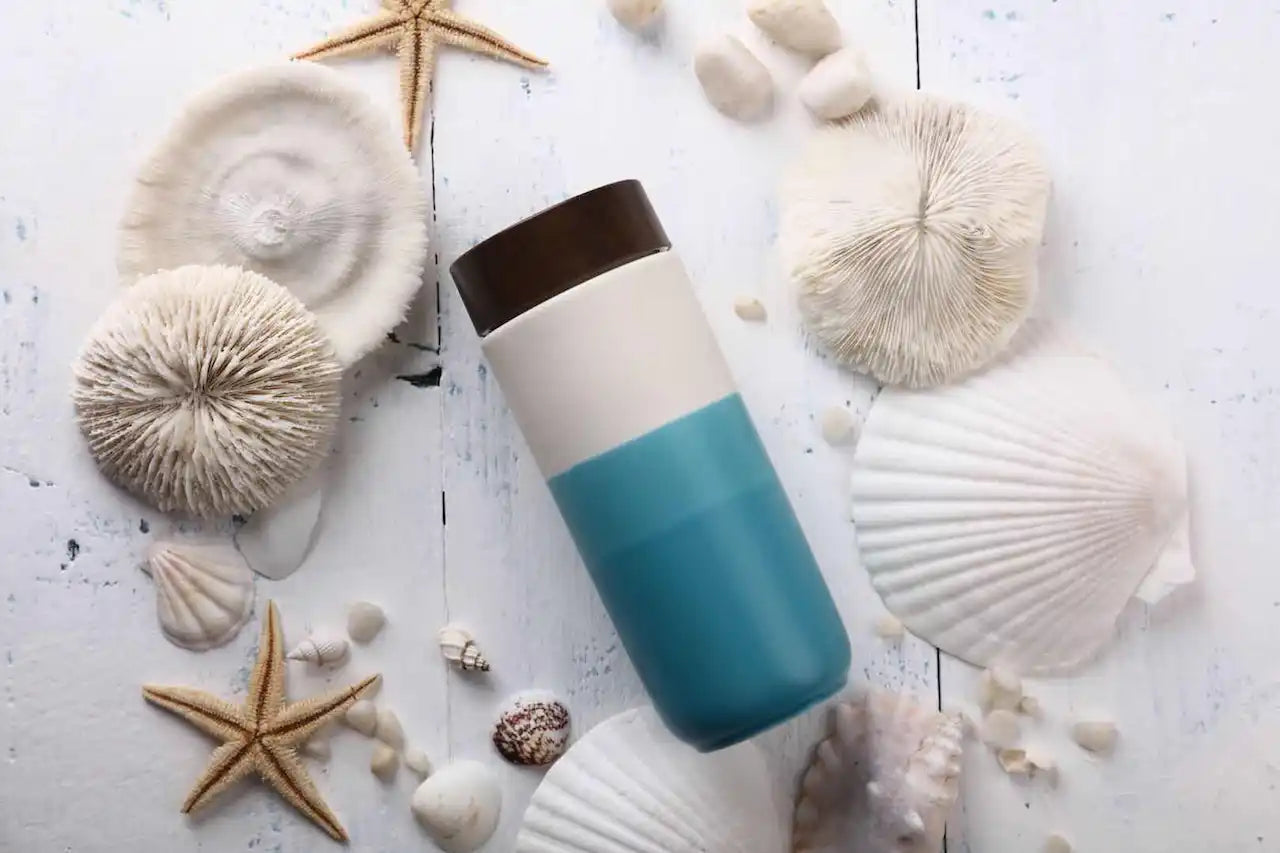 Reusable water bottle with a white and teal color scheme.