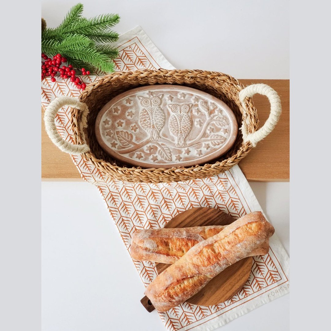 Owl Oval Bread Warmer and Basket with bread and a terracotta plate